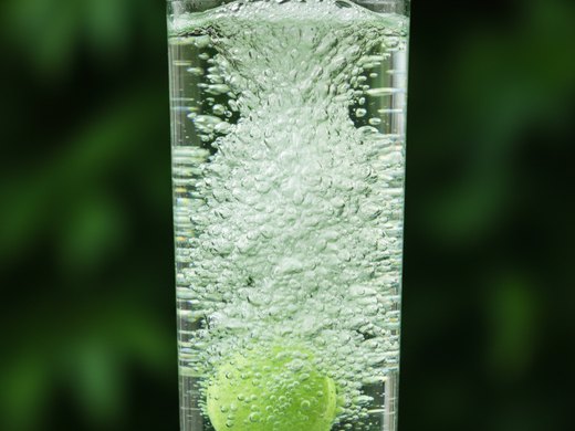 The tablet fizzing and dissolving in water